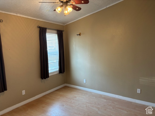 Empty room with a ceiling fan, light wood-style floors, a textured ceiling, and ornamental molding