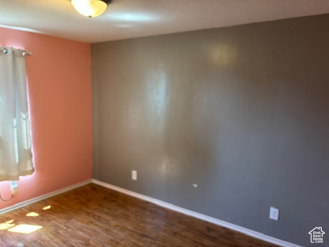 Spare room with wood finished floors and baseboards