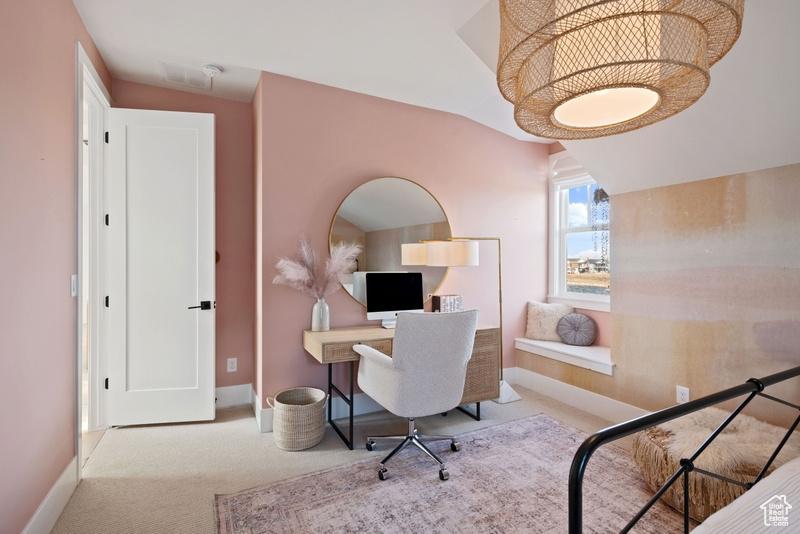Office area with carpet flooring and lofted ceiling