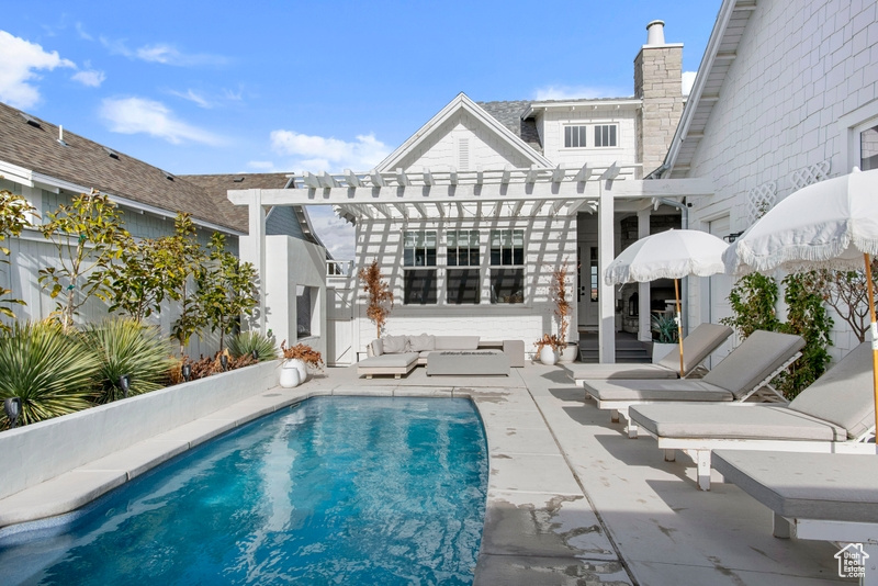 Outdoor pool featuring a pergola, a patio area, and outdoor lounge area