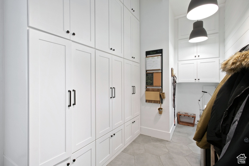 Mudroom featuring baseboards and light tile patterned flooring