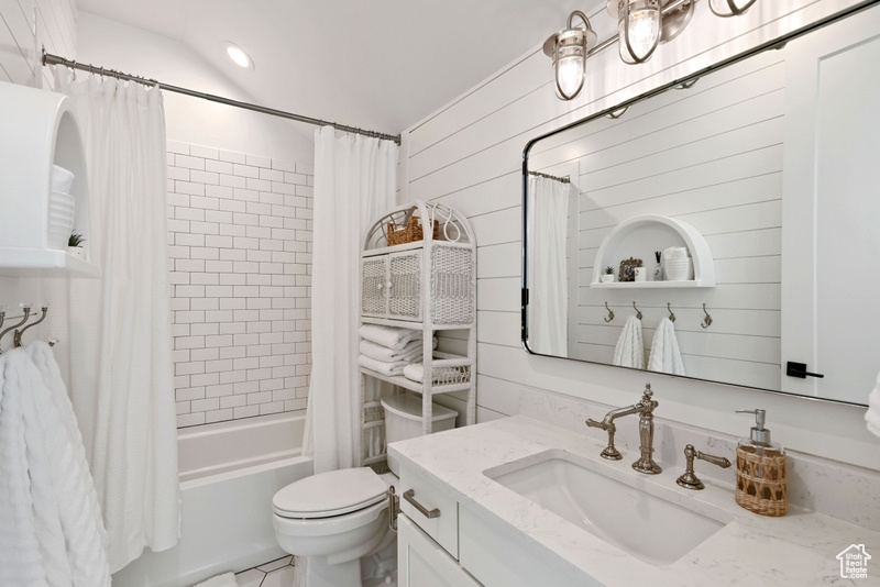 Full bath with vanity and shower / bath combination with curtain