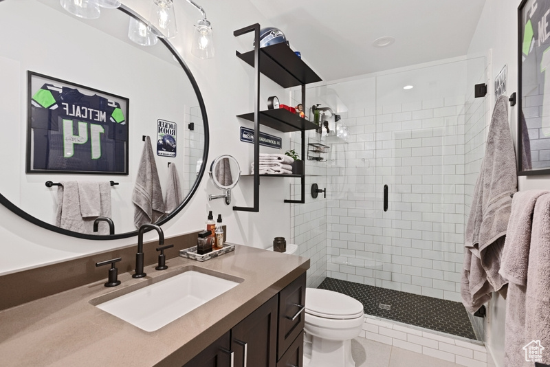 Full bathroom featuring a shower stall, vanity, tile patterned flooring, and recessed lighting