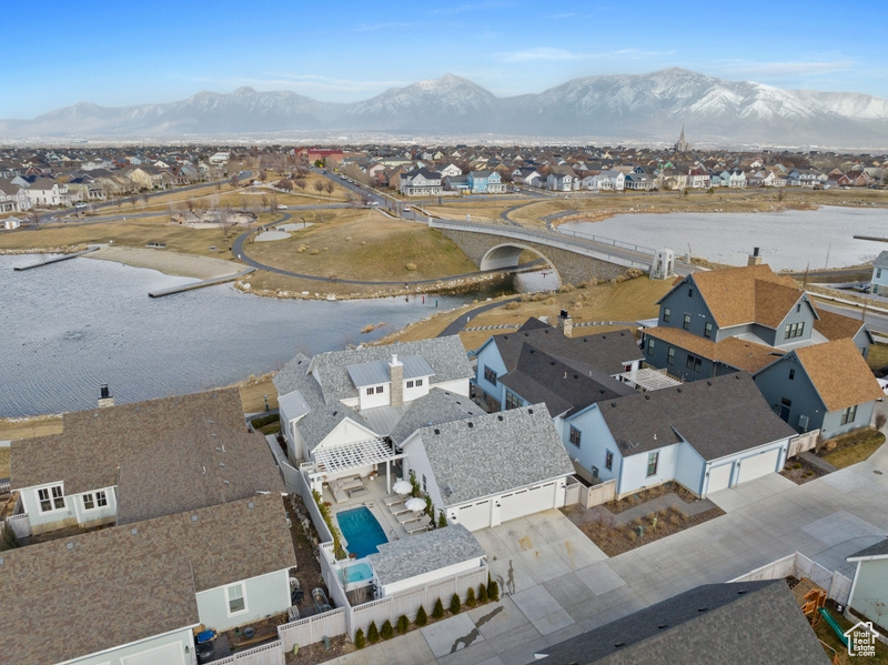 Aerial view of residential area featuring a water and mountain view and a notable bridge