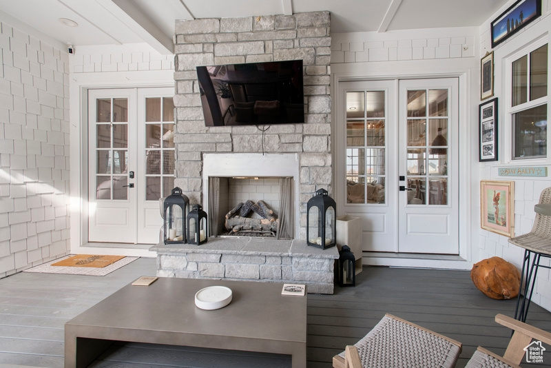 Living area featuring french doors, wood finished floors, and a fireplace