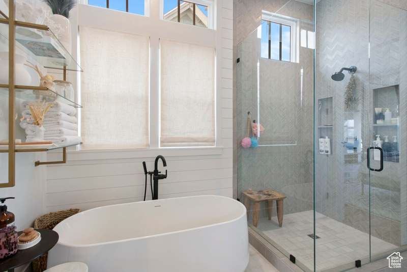 Bathroom featuring a stall shower and a soaking tub