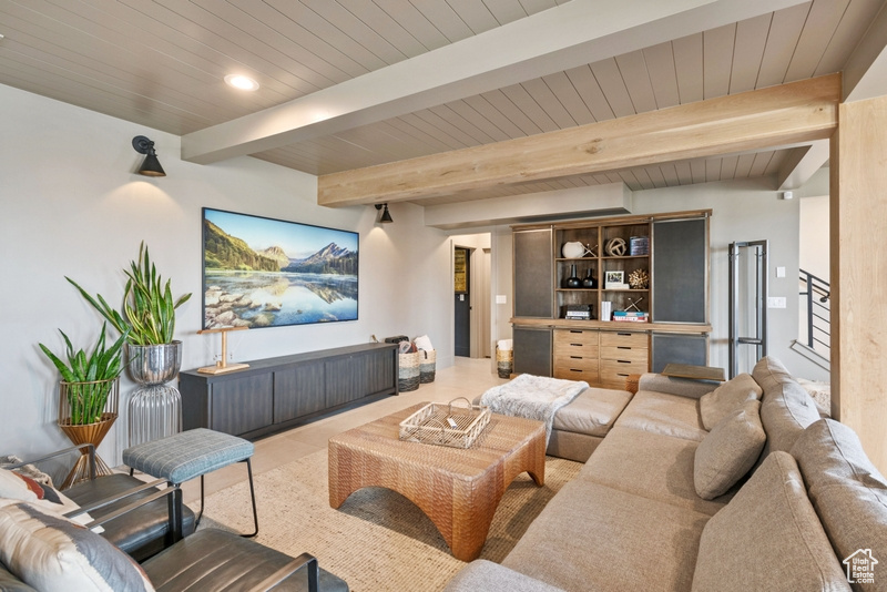 Living area with a wood ceiling with exposed beams, stairs, recessed lighting, and tile patterned flooring