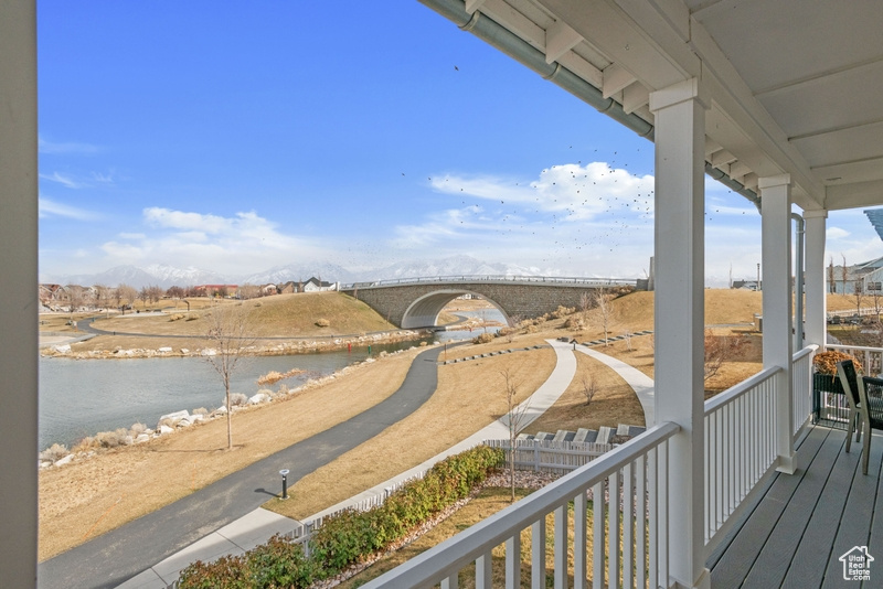 Balcony with a water and mountain view