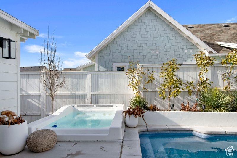 View of swimming pool featuring an in-ground hot tub