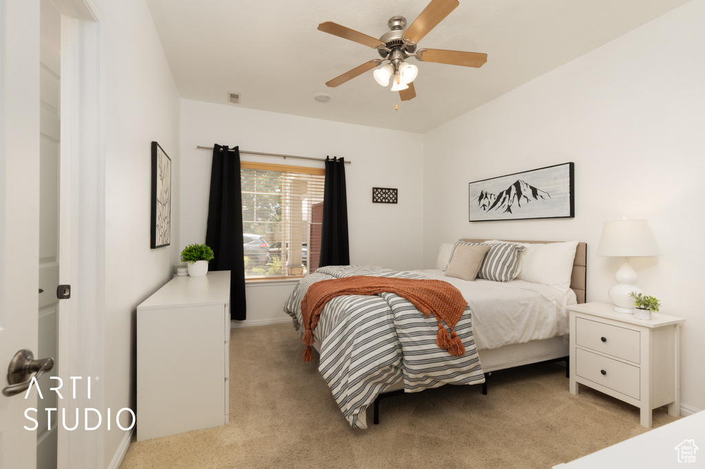 Bedroom featuring light colored carpet and a ceiling fan