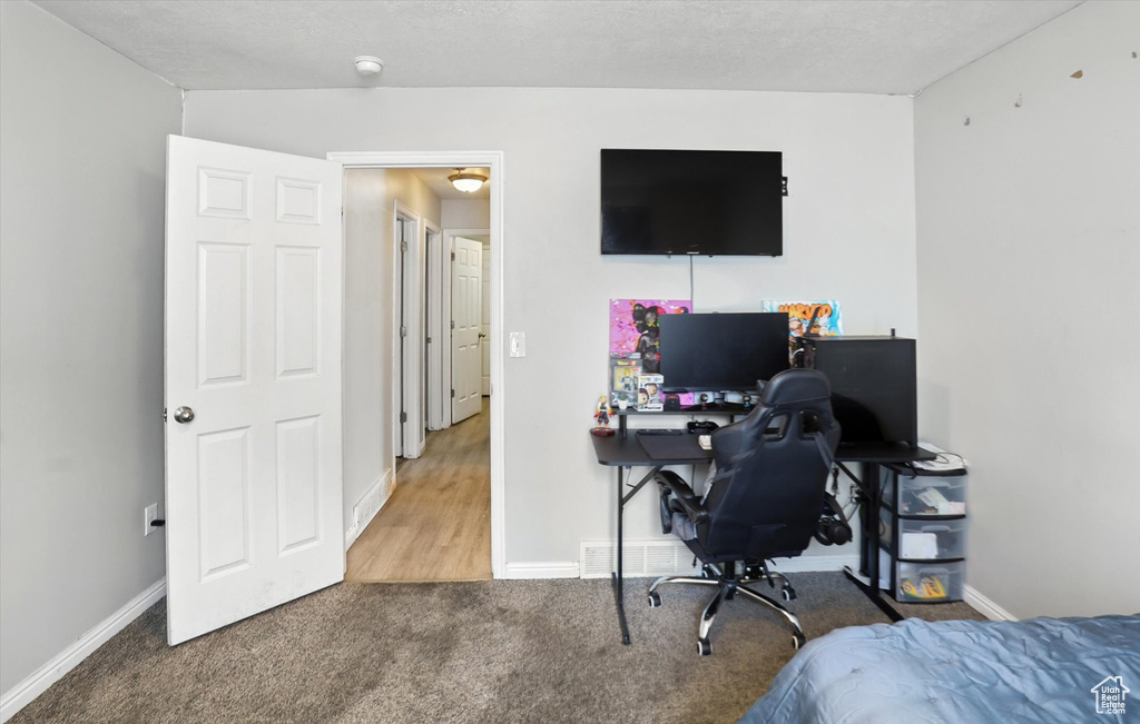 Bedroom featuring carpet flooring and an office area