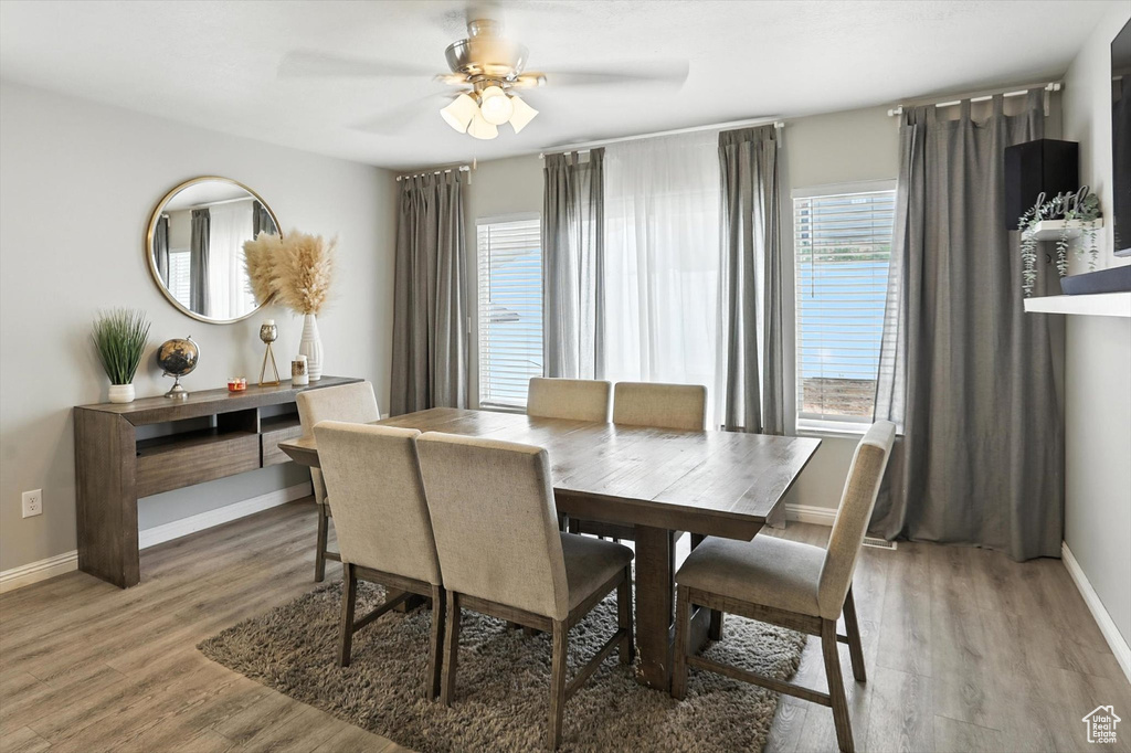 Dining space with light wood-style flooring and ceiling fan