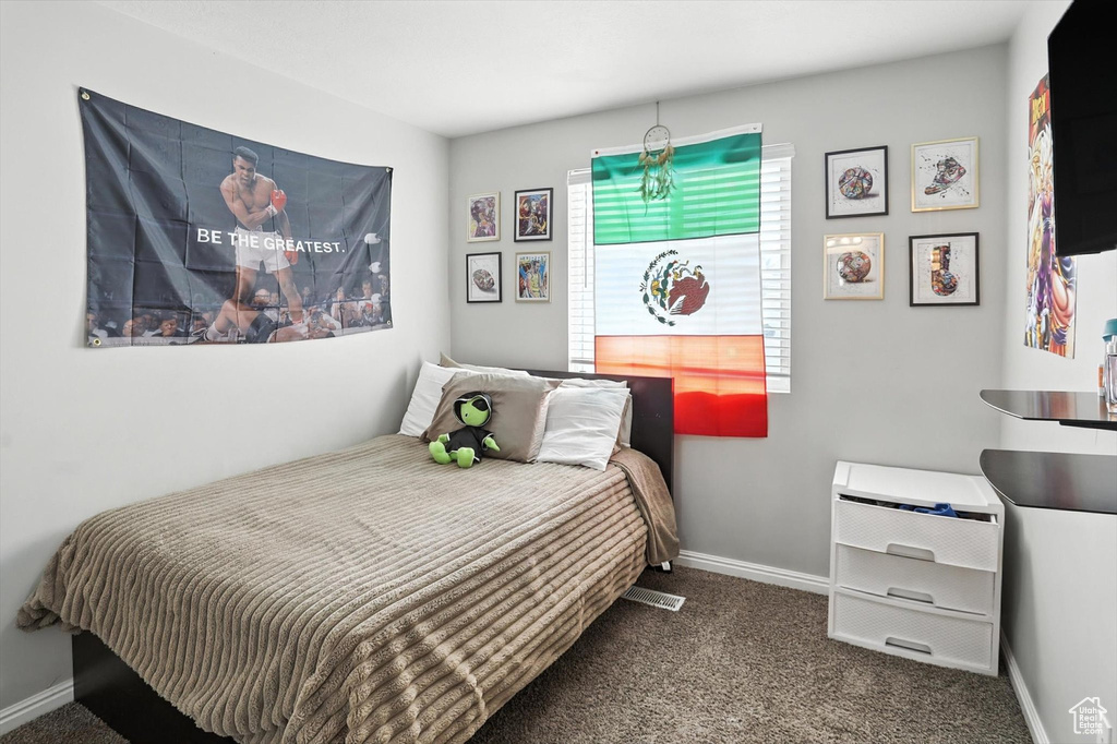 Carpeted bedroom with baseboards