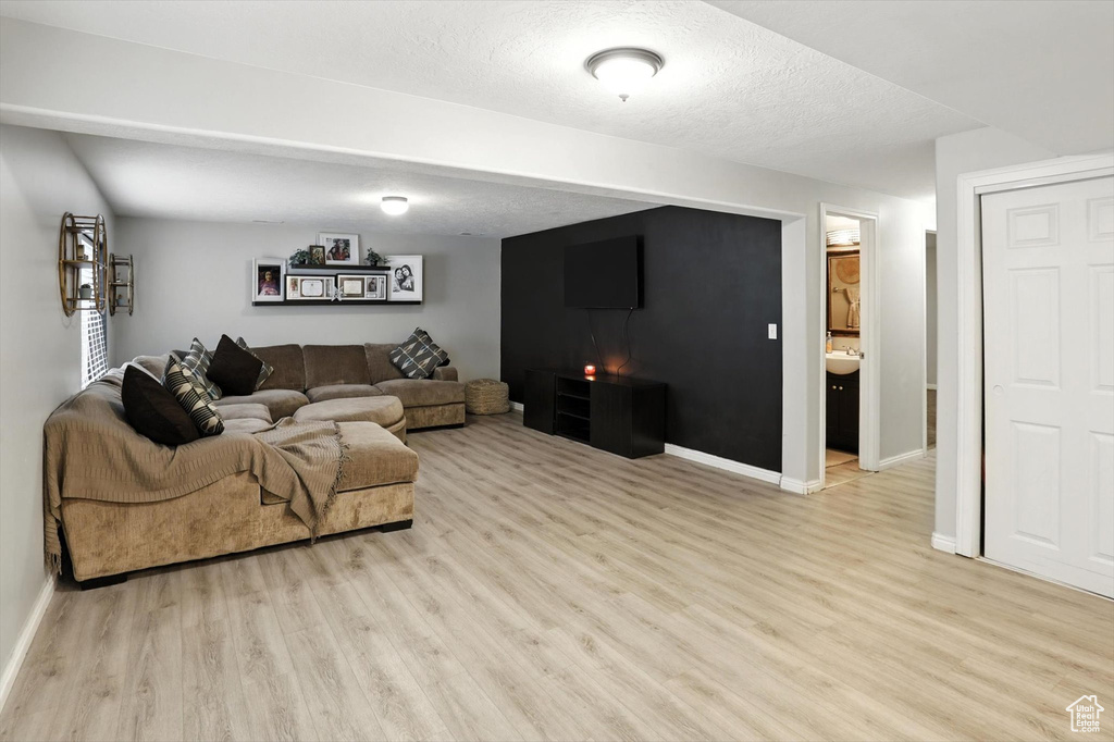 Living area with light wood finished floors and baseboards