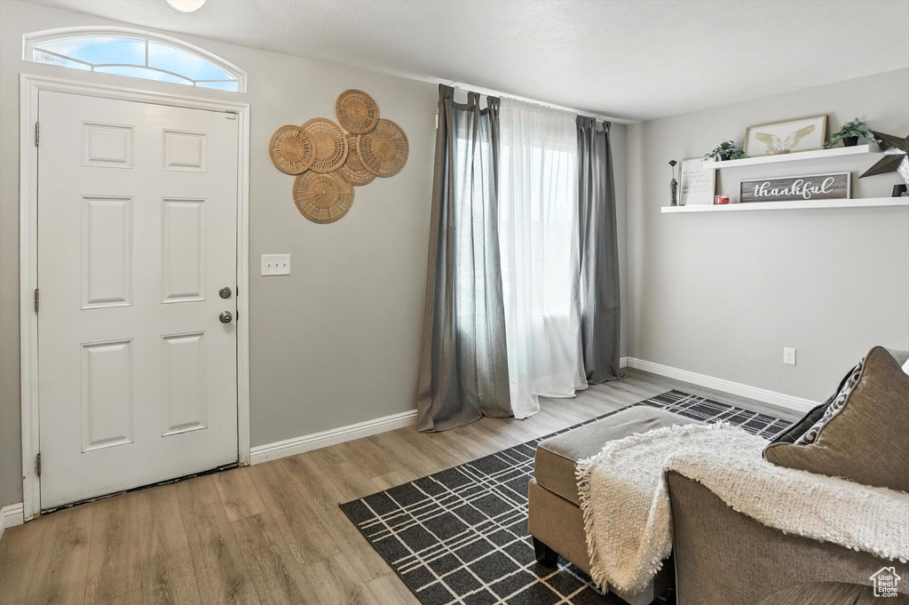 Foyer featuring wood finished floors and baseboards