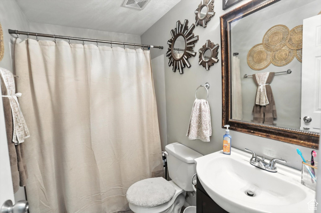Bathroom with vanity and curtained shower