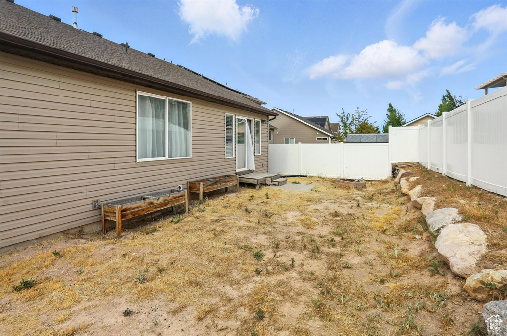 View of fenced backyard