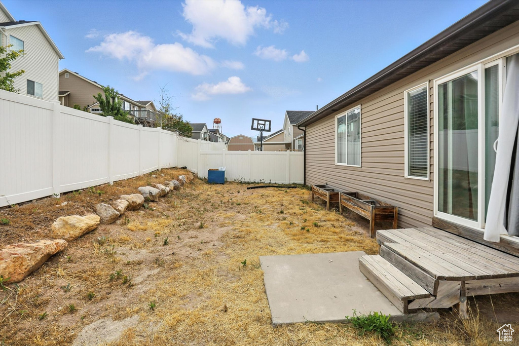 Fenced backyard featuring a residential view
