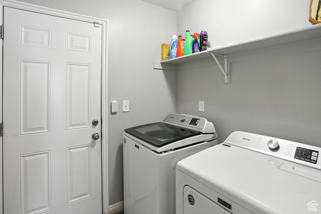 Washroom with washer and clothes dryer