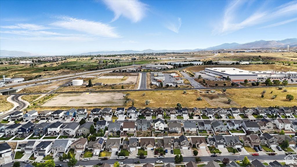 Aerial overview of property's location with a mountain backdrop and nearby suburban area