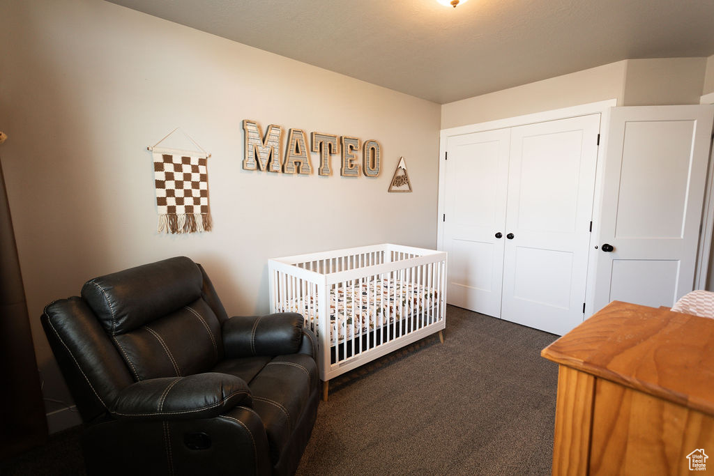 Bedroom featuring carpet and a closet