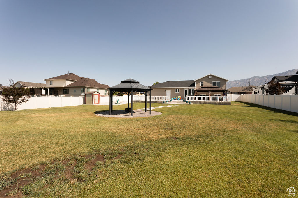 Fenced backyard with a gazebo and a shed