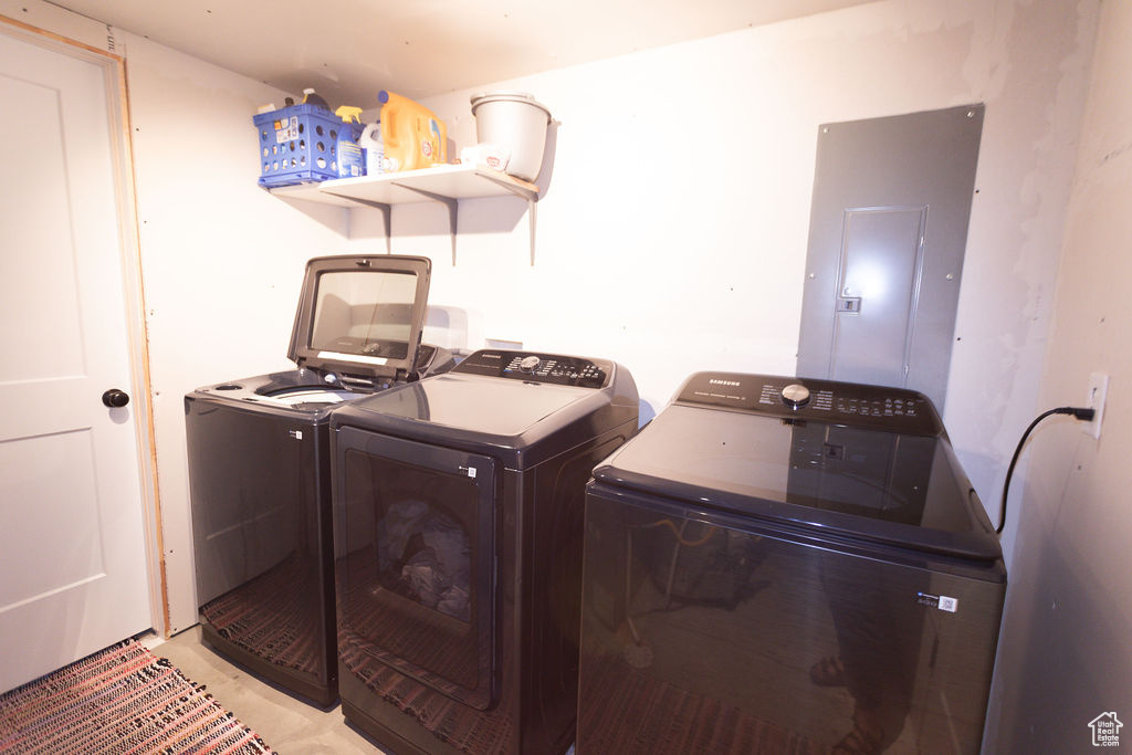 Laundry room with electric panel and independent washer and dryer