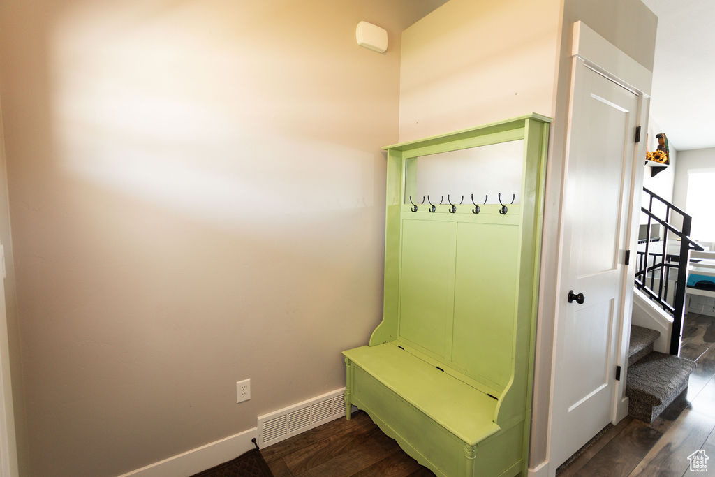 Mudroom with dark wood-style floors and baseboards