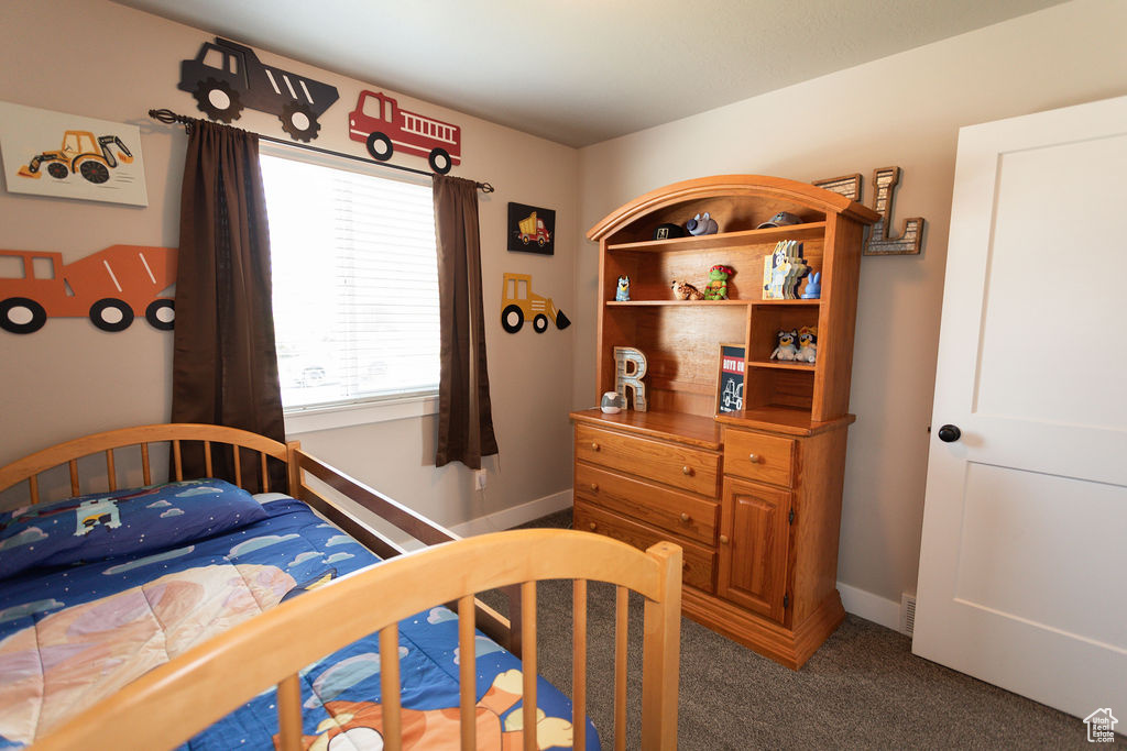 Carpeted bedroom featuring baseboards