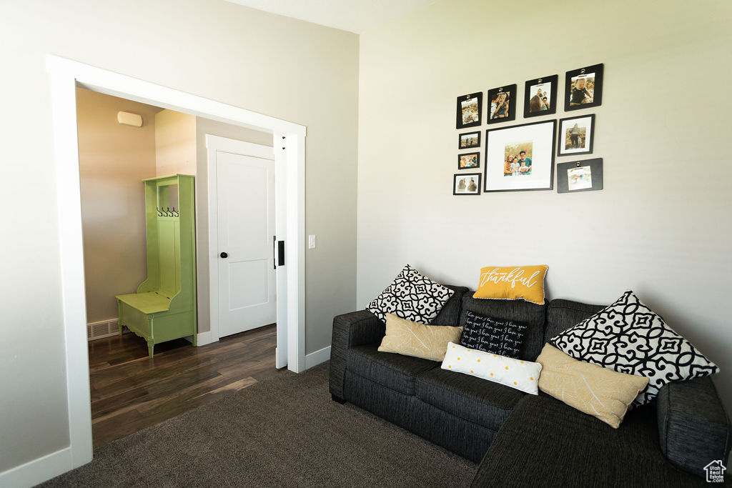 Living area with carpet flooring and baseboards