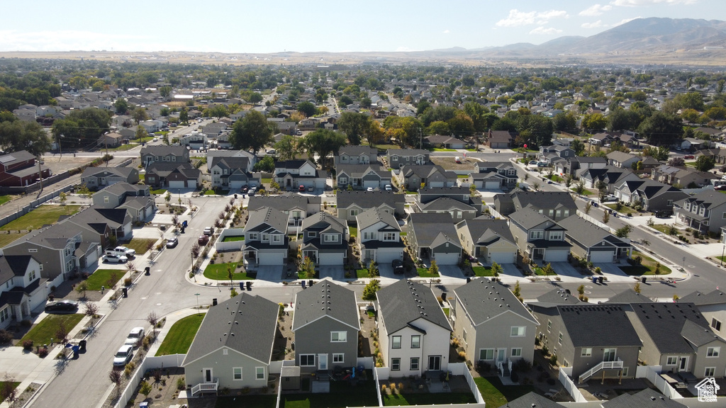 Aerial view of property's location featuring mountains and nearby suburban area