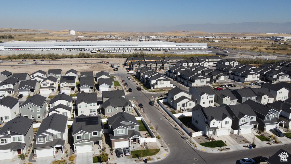 Aerial view of property and surrounding area featuring nearby suburban area