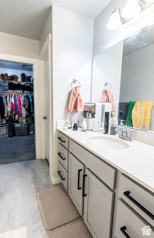 Bathroom featuring vanity and a spacious closet