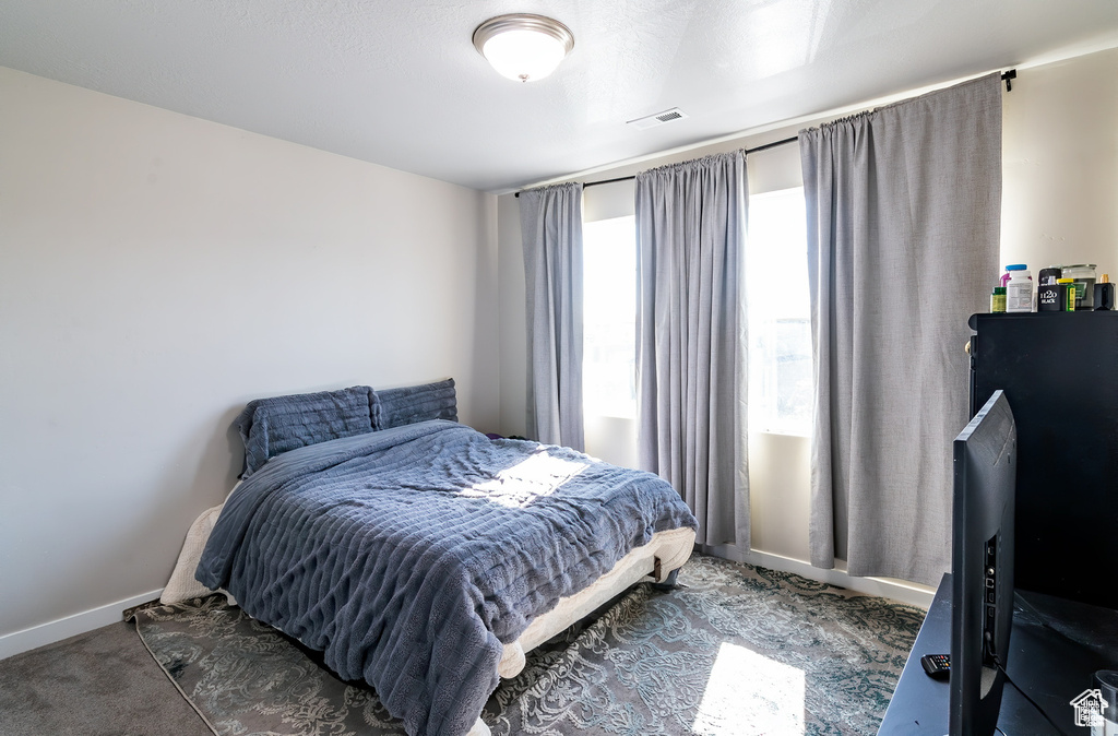 Carpeted bedroom featuring baseboards