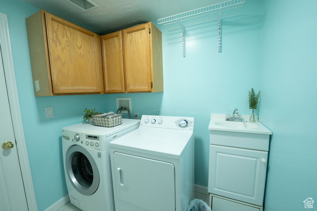Laundry room featuring washing machine and dryer and cabinet space