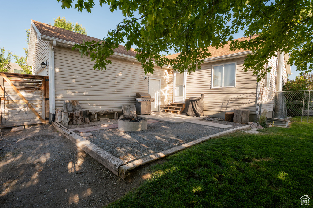 Rear view of property featuring entry steps and a patio area