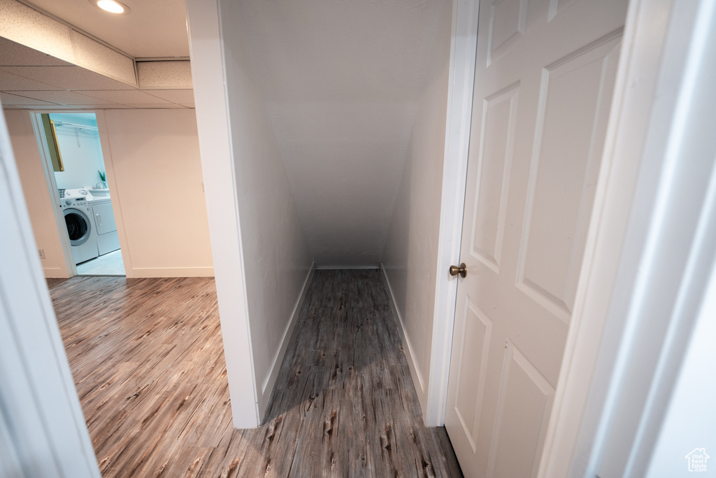 Hallway featuring washing machine and clothes dryer and wood finished floors