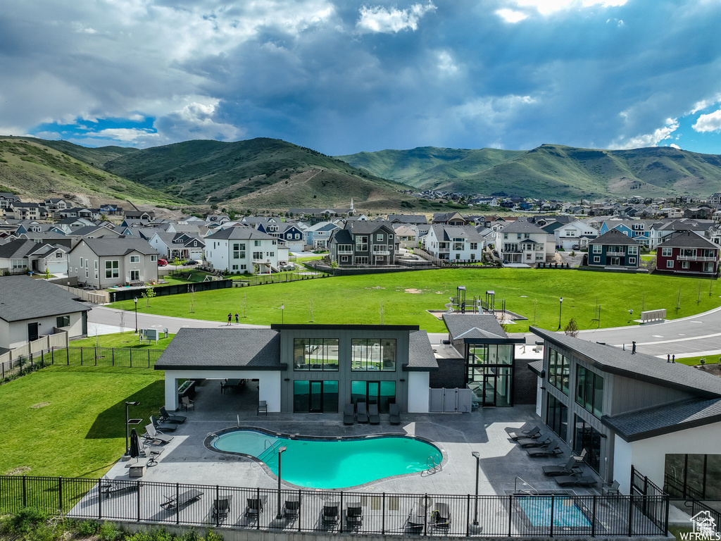 View of pool featuring a residential view, a mountain view, and a patio