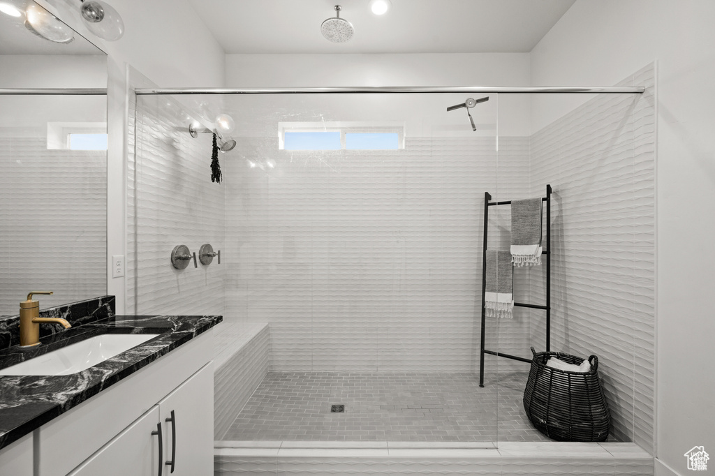 Full bathroom with vanity and a tile shower