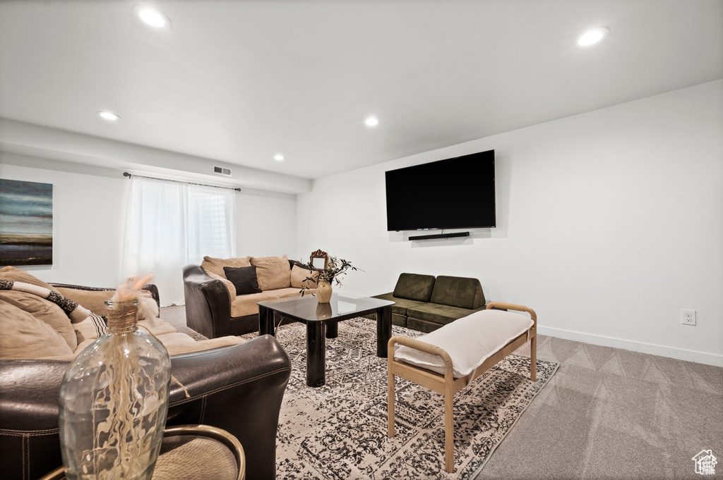 Carpeted living room with recessed lighting