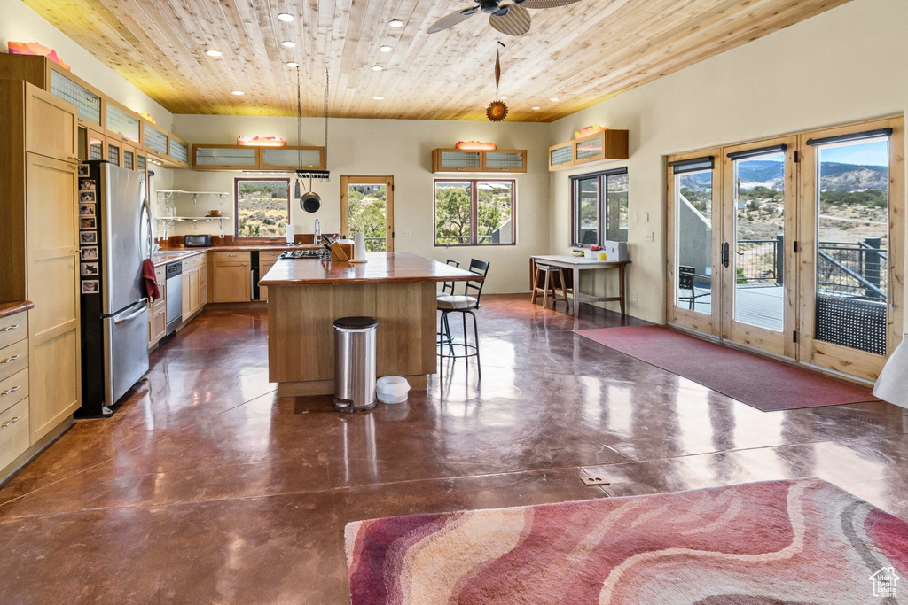 Kitchen featuring appliances with stainless steel finishes, wood ceiling, plenty of natural light, recessed lighting, and a kitchen island