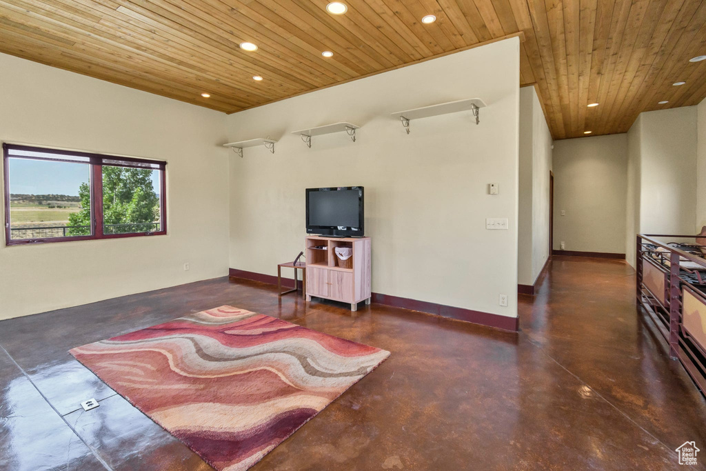 Living room with wooden ceiling, finished concrete flooring, and recessed lighting