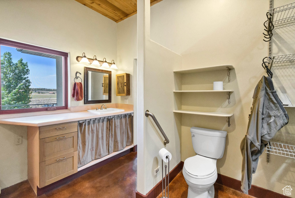 Bathroom featuring vanity, wooden ceiling, finished concrete flooring, and lofted ceiling