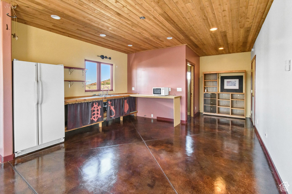 Interior space featuring wood ceiling, recessed lighting, and concrete floors