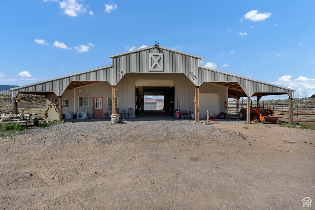 View of outbuilding featuring dirt driveway