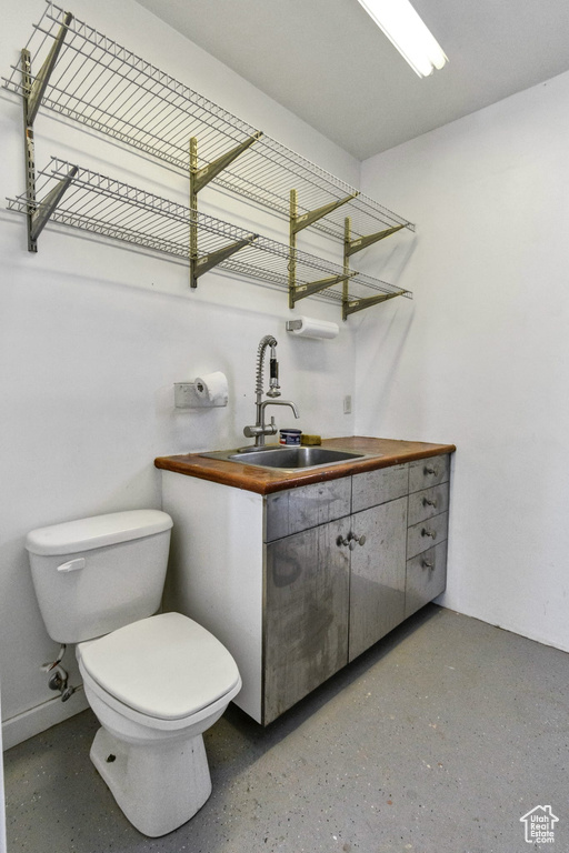 Half bathroom featuring toilet and vanity