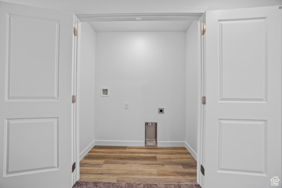 Laundry area with electric dryer hookup and wood finished floors