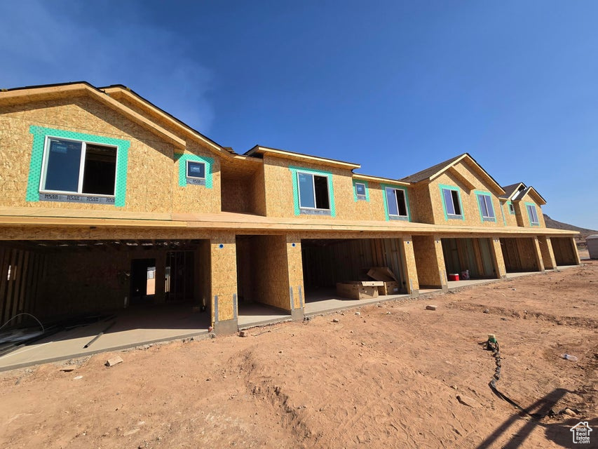 View of front of house featuring a patio area and an attached garage