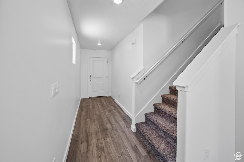 Entrance foyer featuring wood finished floors, stairs, and recessed lighting