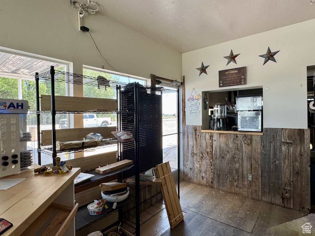 Dining space with hardwood / wood-style flooring, healthy amount of natural light, and a wainscoted wall
